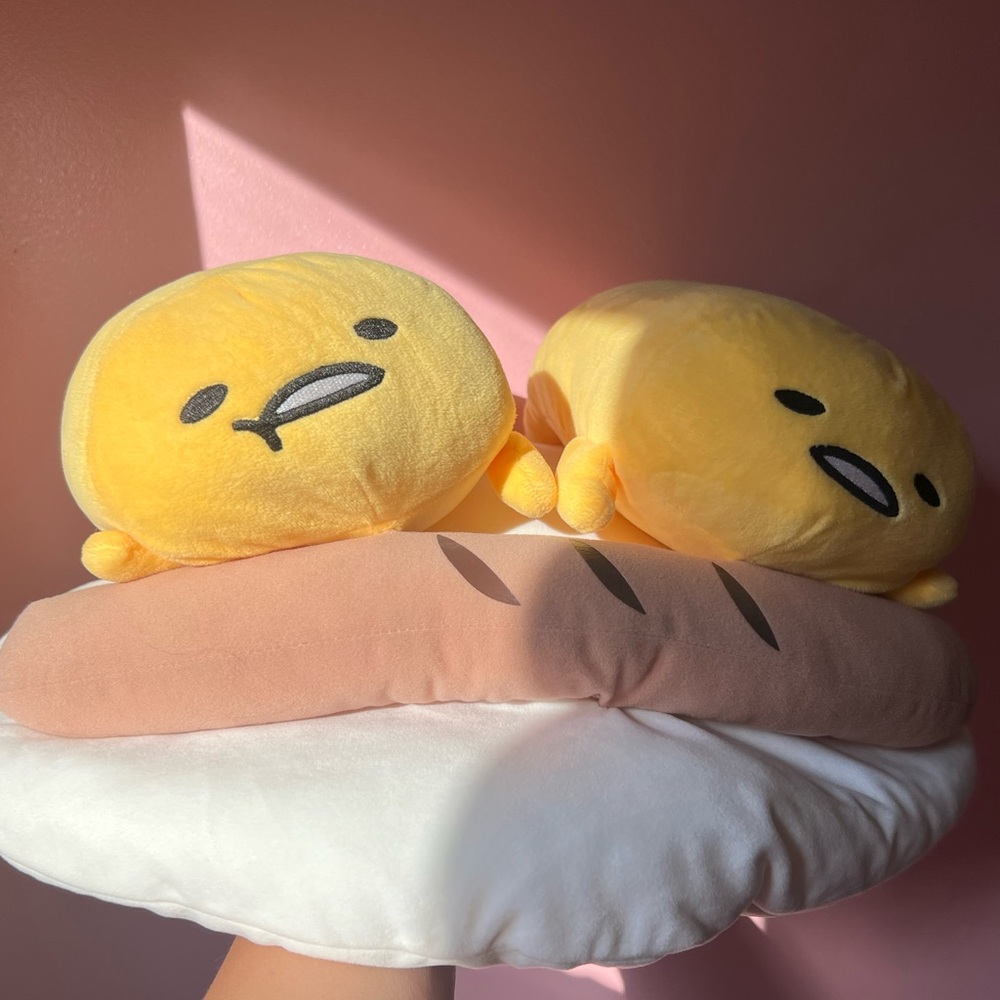 Gudetama lazy eggs laying on egg whites with sausage plushie